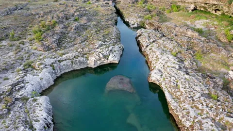 Narrow mountain river flowing through rocky landscape Stock Footage 133200039
