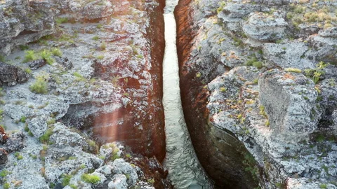 Narrow mountain river flowing through rocky landscape Stock Footage 134367922