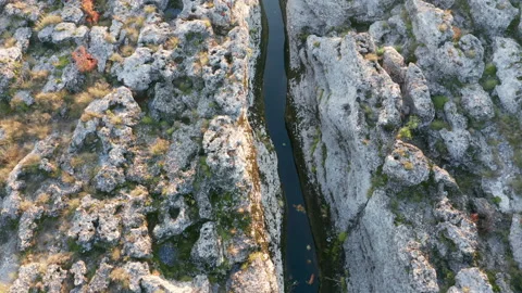 Narrow mountain river flowing through desolate rocky landscape Stock Footage 165358643