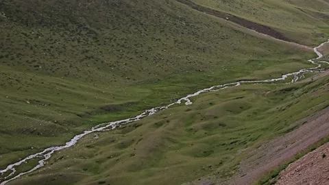 Narrow Mountain River Flowing Through Hills and Mountains Stock Footage 331066318