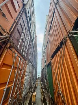Narrow Passage Between Shipping Containers on Container Ship with Dramatic Verti Stock Photos