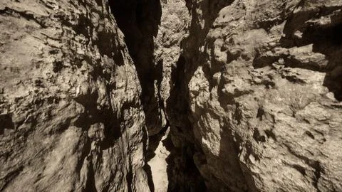 A narrow passage between two large rocks Stock Illustration