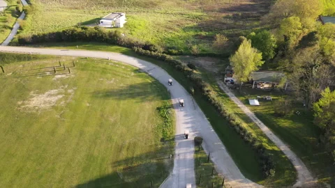Narrow path leading to golf course, trucks with players arriving to sport fiel Stock-Footage 303066558