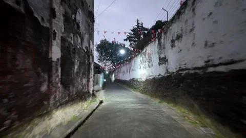 Narrow path lined with weathered walls Stock Footage 345157001