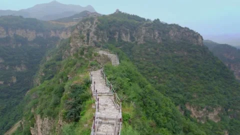 A narrow path at the top of the mountain. Green landscape and blue sky. Stock Footage 133353613