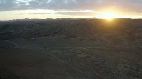 A narrow path winds through a barren desert of interesting colours and geology. Stock Footage 127022695
