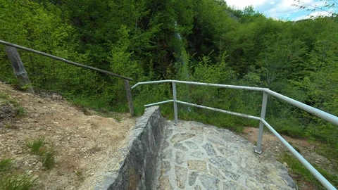 Narrow path winds through green forest. Gostilje Waterfall, Serbia. Stock Footage 337059596