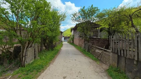 Narrow path winds through old village. Dojkinci village, Serbia Stock Footage 335533970