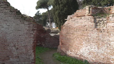 Narrow Pathway Between Collapsed Roman Walls at Ostia Antica Stock Footage 345651211