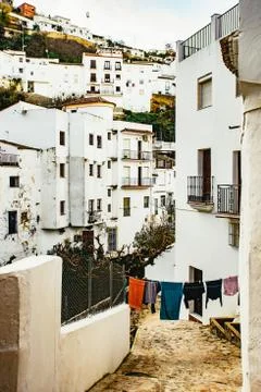 Narrow pedestrian lane between whitewashed houses Stock Photos