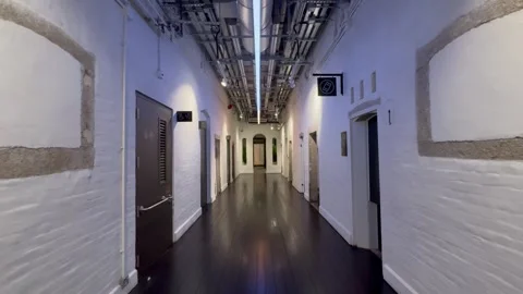 Narrow Prison yard corridor Tai Kwun Hong Kong, motion shot Stock Footage 273189938