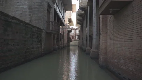 Narrow river pathway in the middle of two bug building wall, Las Casas Stock Footage 132937702
