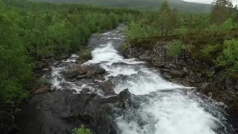 A narrow, rocky stream cascades over smooth Stock Footage 321997233