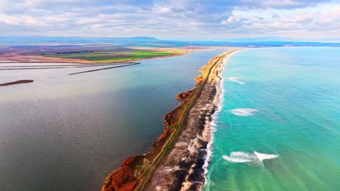 Narrow sand spit separating sea from lake, Pomorie, Bulgaria Stock Footage 336340854