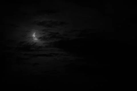 A narrow semicircle of solar disk during eclipse in cloudy cloudy weather, .. Stock Photos