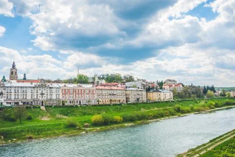 Narrow small river under cloudy rainy sky Foto stock