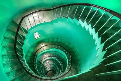 Narrow staircase spiraling down the inside of a lighthouse Stock Photos
