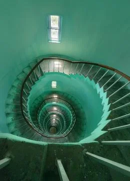 Narrow staircase spiraling down the inside of a lighthouse Stock Photos