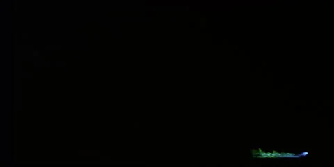 A narrow stream of blue liquid fire topped with tiny green flames runs across Stock Footage 59122156