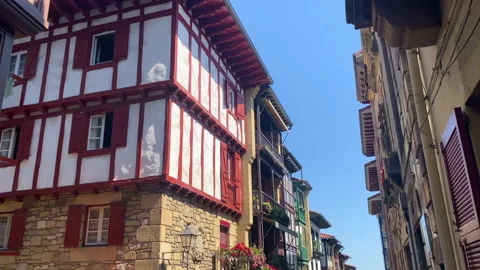 Narrow street and Basque timbered townhouses in Hondarribia on a sunny day Stock-Footage 345145410