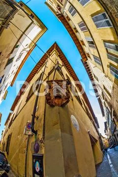 A narrow strip of sky among crowded old buildings Stock Photos