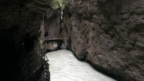 A narrow tunnel with a river running through it Stock Footage 313555089