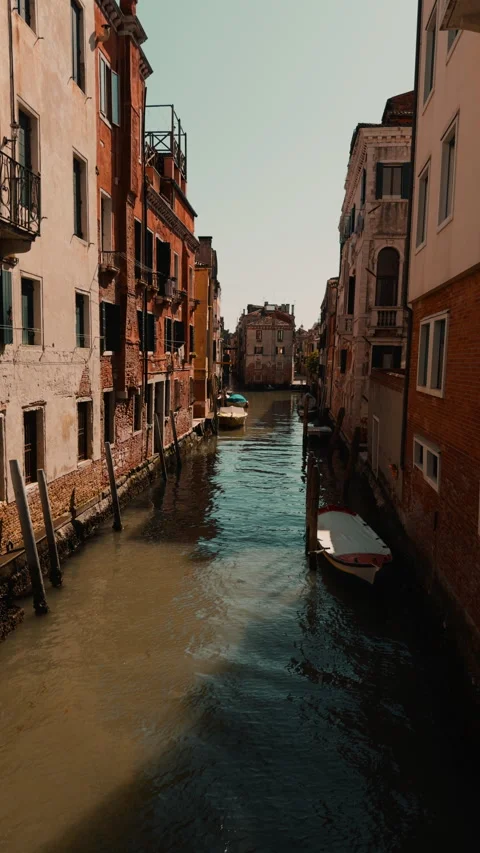 Narrow Venice canal between warm toned buildings Stock Footage 336712384