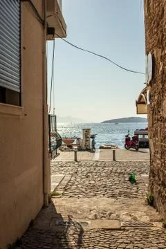 A narrow view of sea between old buildings Stock Photos