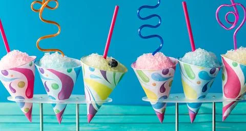 A narrow view of a various snow cones with crazy straws. Stock Photos