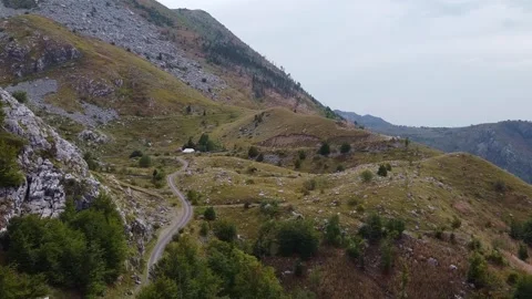 Narrow winding road traversing remote mountainous landscape in Montenegro Video stock 342774318
