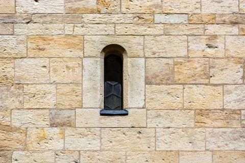 Narrow window in the wall. Stock Photos