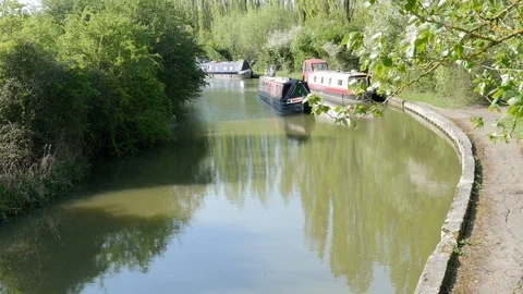 A narrowboat drives along a canal Stock Footage 106989494
