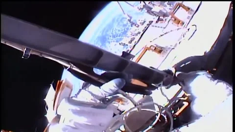 NASA astronauts installing power and data cable to International Space Station Stock Footage 265579740