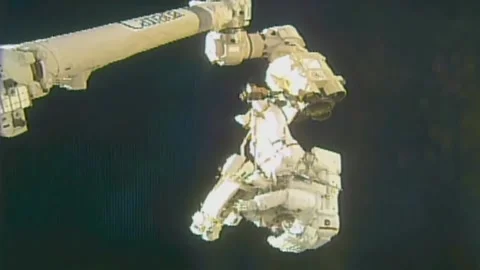 NASA astronauts replacing external camera to International Space Stations truss Stock Footage 265579749