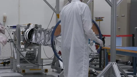 NASA engineers testing Europa Clipper's magnetometer boom in a clean room Stock Footage 289534426
