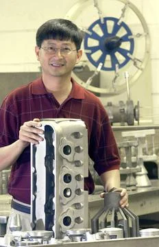 NASA structural materials engineer, Jonathan Lee, displays blocks and pist... Stock Photos