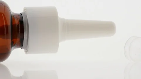 Nasal spray and cap on white background - pan from right to left Stock Footage 104528403