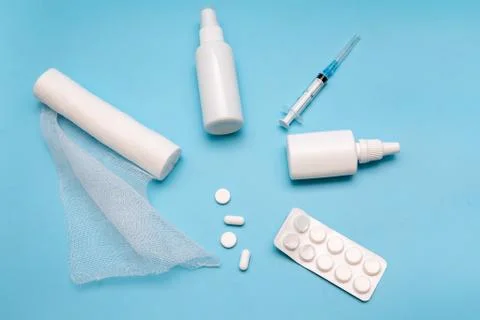 Nasal spray, pills, syringe, bandage injection on a blue background. Medicine Stock Photos