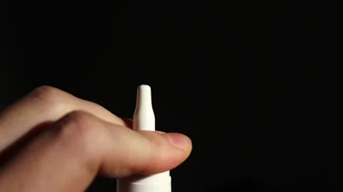Nasal spray slow release small drops on black background. Stock Footage 303600145