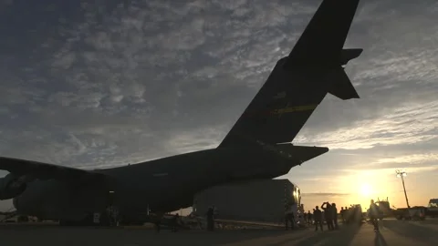 NASA's Europa Clipper spacecraft offloading from C-17 Globemaster II at dusk Stock Footage 281840359