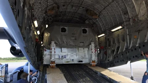 NASA's Europa Clipper spacecraft offloading from C-17 Globemaster aircraft Stock Footage 281840378