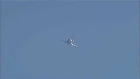 NASA's Space Shuttle Atlantis banking to the left while approaching the runway Stock Footage 283627213
