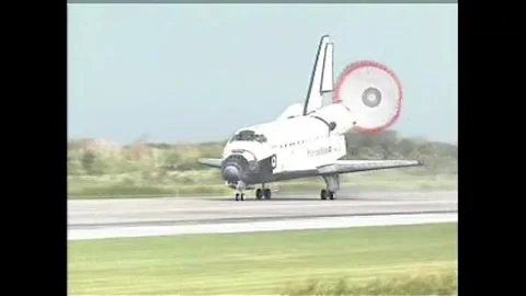 NASA's Space Shuttle Atlantis touching down with drogue at Kennedy Space Center Stock Footage 282976215