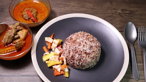 Nasi dagang special brown white rice cooked with coconut milk pickled fruit vege Stock Footage 155388053