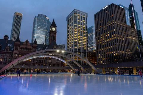 Nathan Phillips Square ice skating with Toronto City Hall and skyline Stock Photos