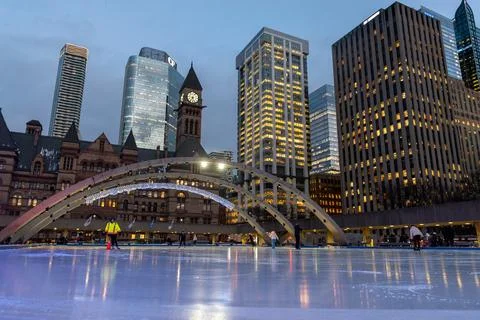 Nathan Phillips Square ice skating in Toronto at dusk Stock Photos