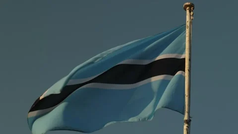 The national flag of Botswana waves and ripples in the wind against the sky Stock Footage 346550818