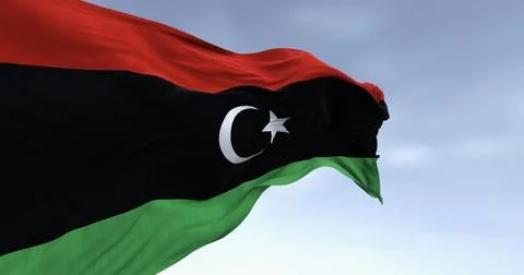 National flag of Libya waving on a clear day. Stock Illustration