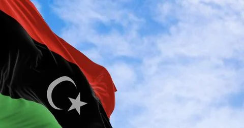 National flag of Libya waving on a clear day. Stock Illustration