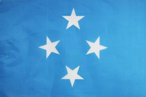 National flag of the state of Micronesia close-up. State background. Stock Illustration
